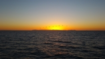 Sunset behind Catalina Island from Newport Beach CA  x