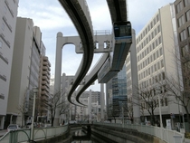 Suspended monorail cutting through the city