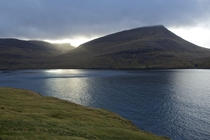 The Autumn sun peaking through the mountains on Vgar in The Faroe Islands 