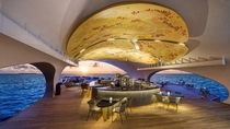The ceiling of the Whale Bar at the St Regis Vommuli Resort in Maldives adorned with a work that incorporates pyrography a traditional Maldivian art form 