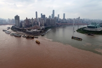 The clear waters of the Jialing River join the muddy floodwaters of the Yangtze River in Chongqing China 