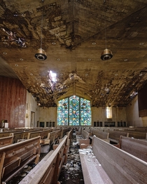 The colorful stained glass windows remain in tact as the abandoned church around it deteriorates 