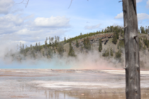 The colors from Grand Prismatic in Yellowstone reflect into the steam rising from it 