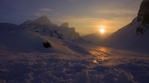 The first light of day reflected off of the snow in Leukerbad Switzerland - 