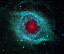 The Helix Nebula from NASAs Spitzer Space Telescope The Nebula resembles a monsters eye with the mixture of green and blue being the iris and the red starlet as the pupil How beautiful --