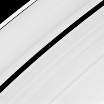 The higher resolution view of saucer-shaped Pan Saturns moon glides through the Encke Gap in Saturns rings