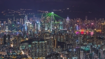 The International Financial Centre and other skyscrapers shooting green laser beams in Hong Kong