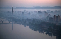 The Juche Tower rises high above the morning mist along the Taedong River in Pyongyang North Korea Wong Maye-E 