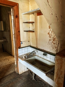 The kitchen in an old farmhouse no stove no counter tops just a pantry off to the side