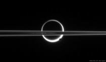 The large circular object in the center of the image is Titan The dark spot in the center is the main solid part of the moon The bright surrounding ring is atmospheric haze sunlight scattering gas CreditNASA ESA JPL SSI Cassini Imaging Team
