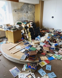 The library room of a hydrometeorology station with leaky walls falling apart Incredible selection ranging from building soviet rockets through good employee motivational literature to korean leader speeches Cca th floor most of the numerous rooms were em