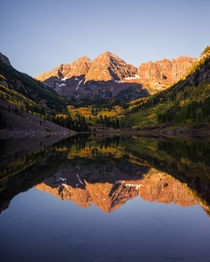 The Maroon Bells on a Fall morning reflected in the lake 