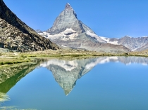 The Matterhorn reflected in Riffelsee along the Gornergrat hike in Zermatt Switzerland
