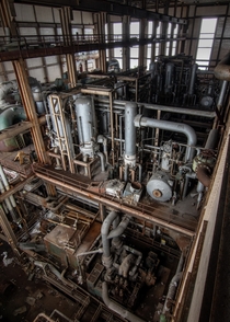 The maze of pipes inside a large abandoned power plant