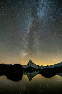 The Milky Way nicely aligns with the Matterhorn This is my first try at astrophotography  considering my equipment I am very happy with the result Zermatt Switzerland 