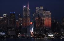 The moon rises in New York City Gary Hershorn 