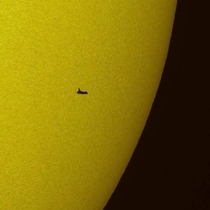 The NASA space shuttle Atlantis is seen in silhouette during solar transit Tuesday May   from Florida This image was made before Atlantis and the crew of STS- had grappled the Hubble Space Telescope