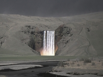 The Skgafoss waterfall amidst a landscape covered in ash spewed from the volcano Eyjafjallajkull in  Iceland  photo by Sverrir Thorolfsson