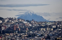 The snow-capped Cotacachi volcano rises above Quito Ecuador