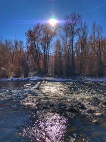 The sun casting purple rays over the Roaring Fork River in Basalt CO x 