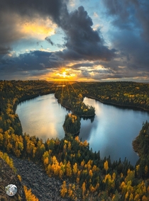 The sun peeking down on peak fall colors in the BWCA Minnesota on the left Canada on the right  keefography