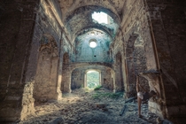 The sun streams into the ruins of a church  Photographed by Oriol Ribera