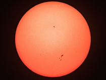 Todays sun through the smoke of the wildfires in California The one group of sunspots was visible by eye 