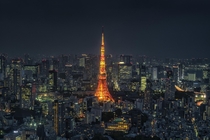 Tokyo tower glows bright above the city 