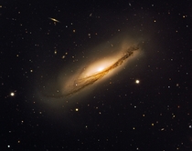 Twin Explosions In Gigantic Dusty Potato Crisp - edge-on spiral galaxy NGC  