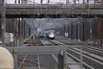 Two Amtrak trains race under the new constant-tension catenary on the Northeast Corridor at Princeton Junction NJ 
