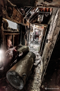 Upstairs hallway of a heavy machinery shop abandoned due to fire damage