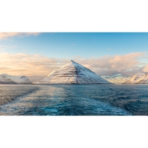 View from a boat of snow covered mountains - Faroe Islands 