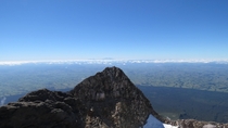 View from Mt Taranaki summit with Mt Ruapehu in the background New Zealand 