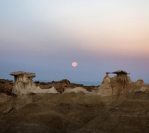 Watched the full moon set at sunrise over the otherworldly Bisti Badlands of New Mexico 