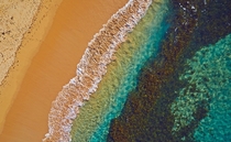 Water and sand mix to create ocean rainbow Manly Beach Sydney Australia px  px By Remy Gerega