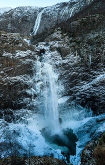 Waterfall in wintertime Mnafossen Norway 