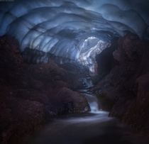 Waterfalls in what appears to be a dimly lit cave in Kamchatka by Daniel Kordan 