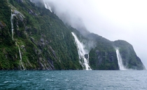 Waterfalls on a windy rainy day at Milford Sound NZ 