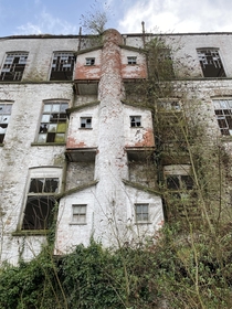 We were exploring an abandoned linen mill in Northern Ireland and saw this structure on the side of the factory does anyone know what its for Each little house type thing is barely big enough to fit a person in each side and there was a floor at each leve