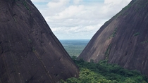 Where two giants meet Amazon rainforest seen through the gap between Cerro Pajarito left and Cerro Mono Cerros de Mavicure Colombia 