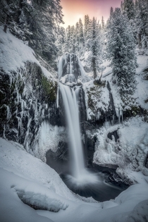 Winters warmth One of the very popular waterfalls in the Gifford Pinchot National Forest during a epic winter sunrise Washington state OC  IG johnperhach_photo_