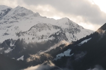 Wispy sunlit clouds covering the mountains of Interlaken Switzerland 